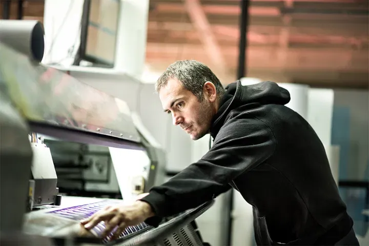 Technician checking a large-format print production run